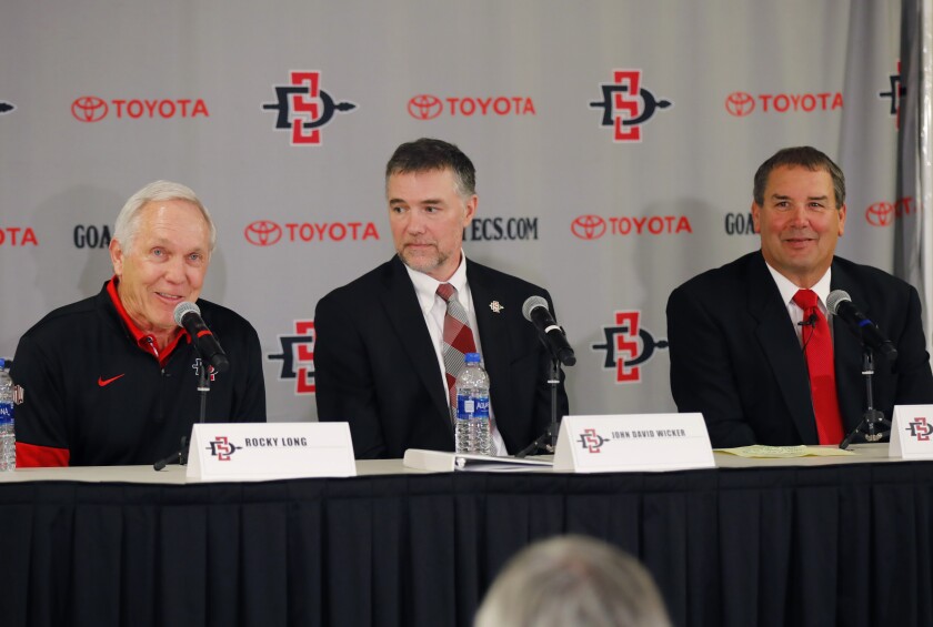 Rocky Long (left) is retiring as San Diego State's football coach, with Director of Athletics John David Wicker (center) announcing Brady Hoke (right) as the new coach.