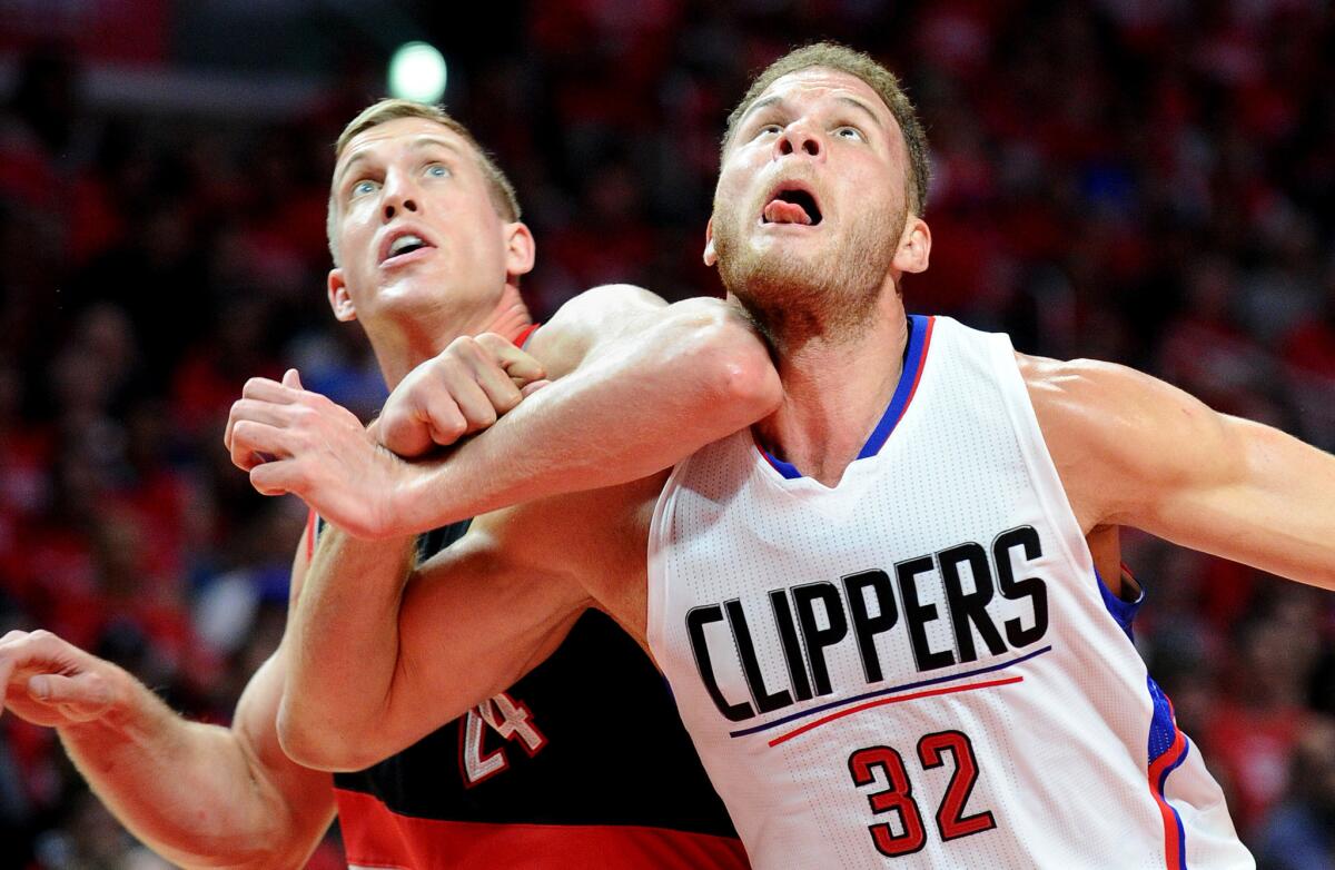 Clippers power forward Blake Griffin battles for rebounding position with Trail Blazers center Mason Plumlee in the first half of a playoff game last season.
