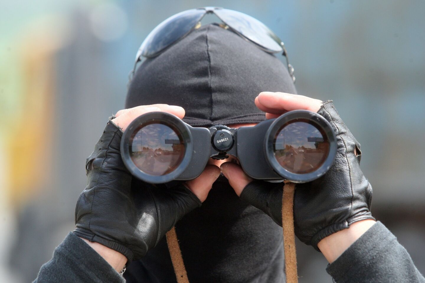 A pro-Russia militant looks through binoculars at a checkpoint on the road from Donetsk to Mariupol in Ukraine on May 15.
