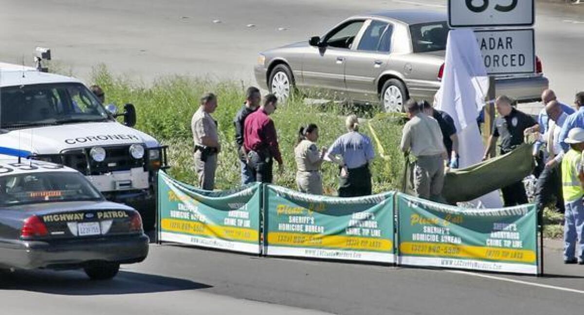 Two men were convicted this week in the 2008 murder of a Mongols Motorcycle Club member gunned down while riding on the 2 Freeway in 2008. Pictured are L.A. County coroner's personnel removing the victim's body on October 8, 2008.