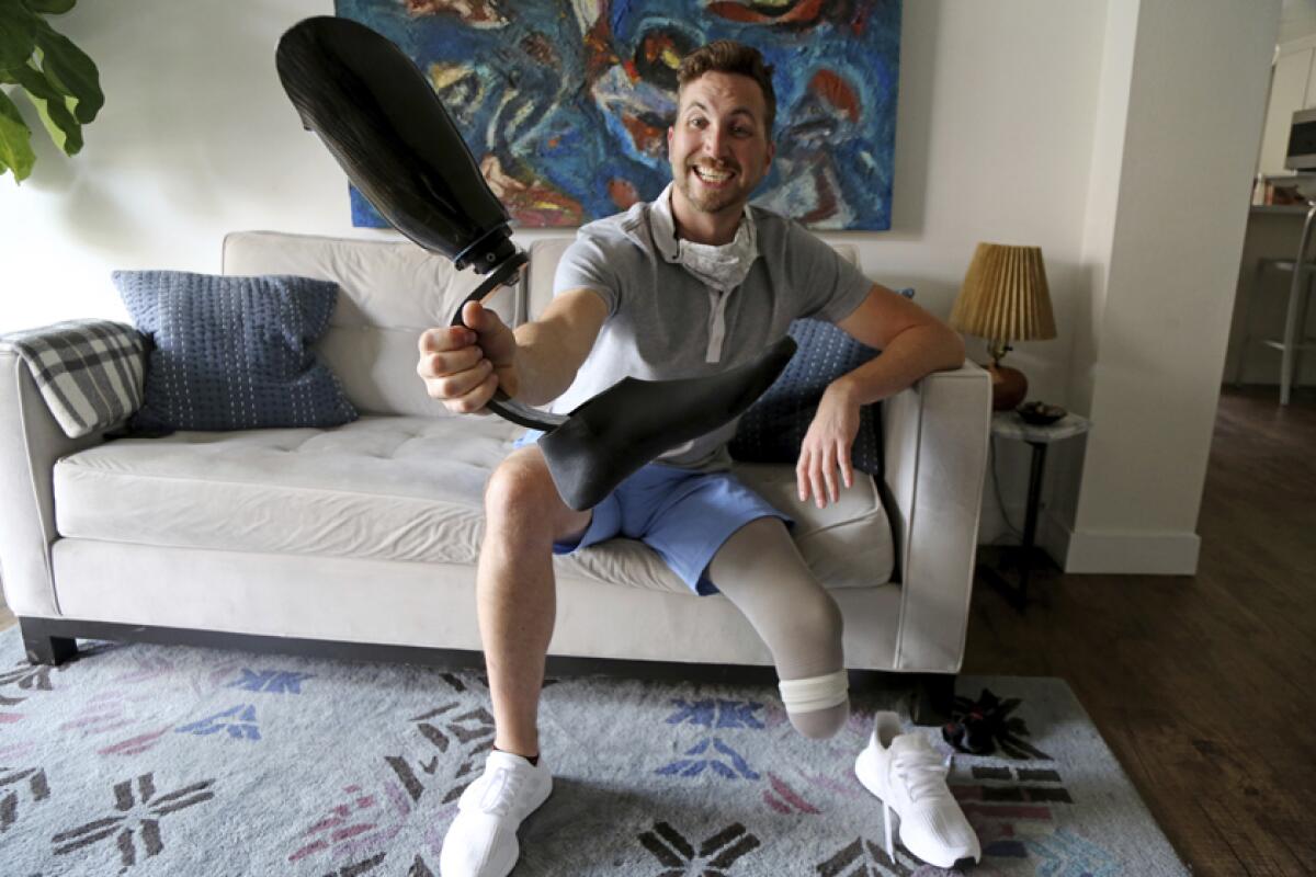 DeWalt Mix displays his prosthetic leg at his Santa Monica home on Wednesday.