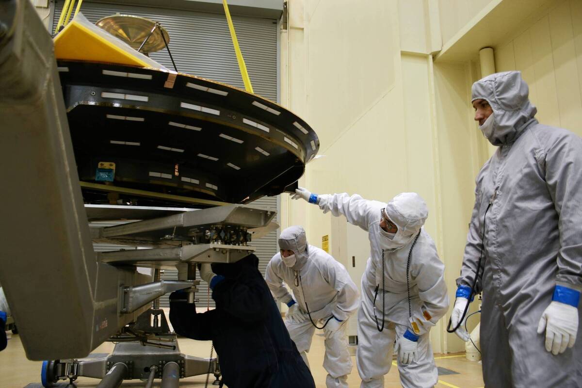 Workers at Lockheed Martin Space Systems south of Denver maneuver an antenna that will be fitted onto the $671-million probe called the Mars Atmosphere and Volatile EvolutioN orbiter, or MAVEN, which needs to be free of earthly contaminants to protect any possible life forms on the Red Planet.