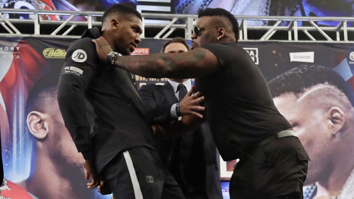 Anthony Joshua, left, is shoved by Jarrell Miller as they pose for photographs during a news conference on Feb. 19, 2019, in New York.