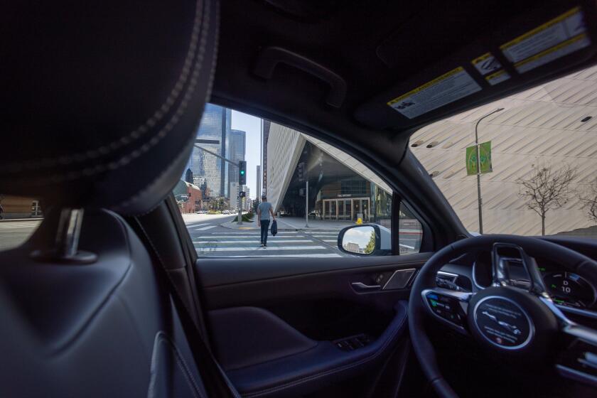 Los Angeles, CA - March 11: (EDS NOTE-NEWS EMBARGO UNTIL WEDNESDAY) A Waymo robotaxi Jaguar I-PACE driverless car passes by The Broad in downtown Los Angeles on Monday, March 11, 2024. Waymo is about to announce the launch of its robotaxi fleet in Los Angeles.  The new service will allow users to go from downtown to Santa Monica, traveling hundreds of miles.  The service is expected to begin this week, but won't be available to everyone for a few more weeks.  Waymo One's fleet is comprised of all-electric Jaguar I-PACEs, the world's first premium self-driving electric vehicle.  Waymo Driver uses fully autonomous technology that is always in control of the vehicle from pickup to destination.  (Allen J. Schaben/Los Angeles Times)