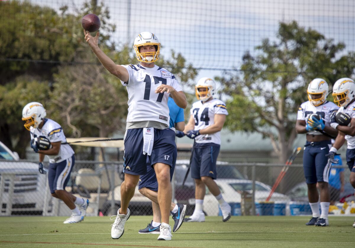 Quarterback Philip Rivers throws a pass as the Los Angeles Chargers conduct their first training camp practice of 2019 at Jack R. Hammett Sports Complex in Costa Mesa on Thursday.