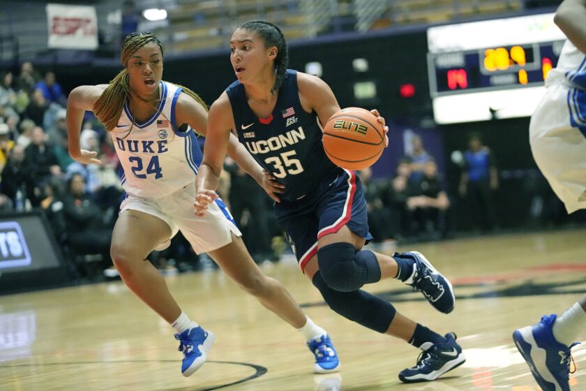Connecticut guard Azzi Fudd (35) goes to the basket as Duke guard Reigan Richardson (24) defends during the first half of an NCAA college basketball game in the Phil Knight Legacy tournament Friday, Nov. 25, 2022, in Portland, Ore. (AP Photo/Rick Bowmer)