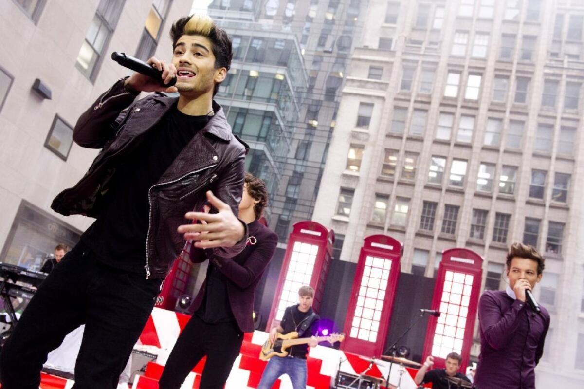 Zayn Malik performs with One Direction on the "Today" show in 2012. Malik announced his exit from the successful British boy band on Wednesday.