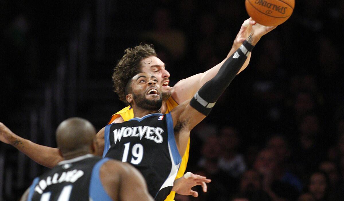 Guard Wayne Ellington, then with Minnesota, and then-Lakers forward Pau Gasol battle for a loose ball during a game in on March 18, 2011.