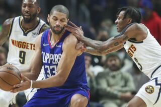 Los Angeles, CA - January 11: Clippers forward Nicolas Batum, center, gets fingers in the face.