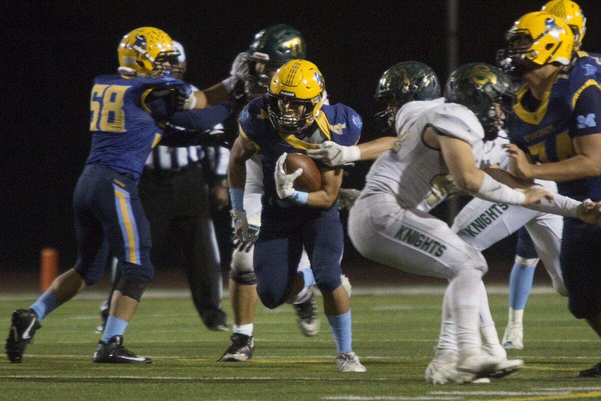 Marina's Pharoah Rush runs the ball for a large gain against Ontario Christian in the quarterfinals of the CIF Southern Section Division 11 playoffs at Westminster High on Friday.