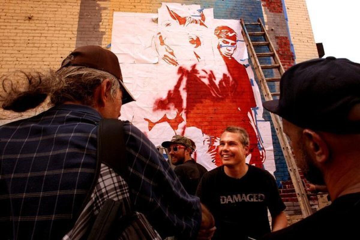 Shepard Fairey, center, greets fans in Los Angeles in August.