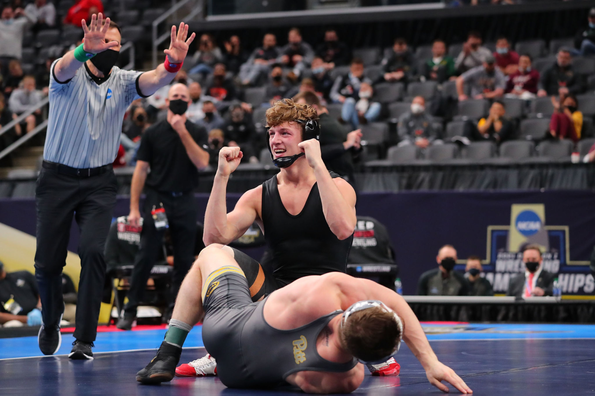 Stanford's Shane Griffith celebrates while wearing no team logos after beating Jake Wentzel