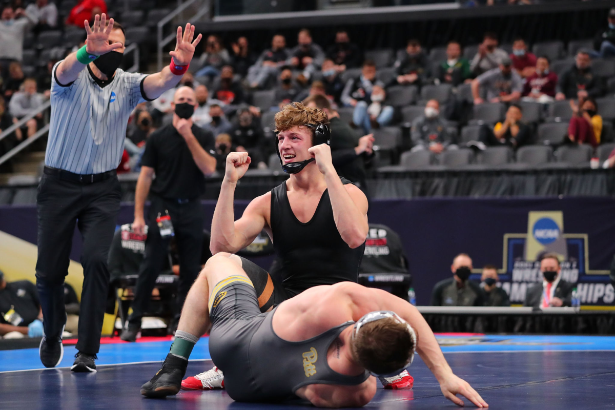 Stanford's Shane Griffith celebrates while wearing no team logos after beating Jake Wentzel 