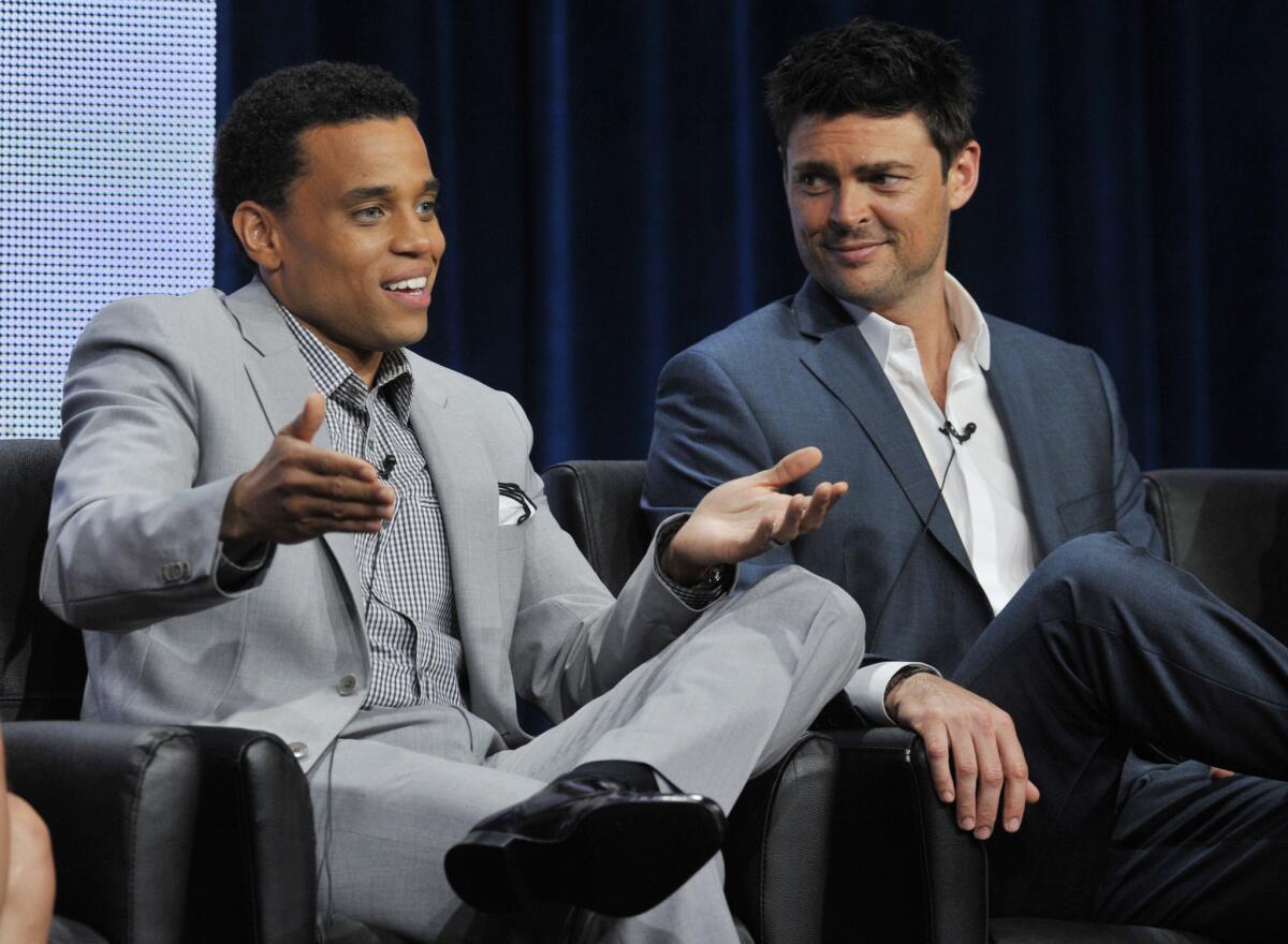 Michael Ealy, left, and Karl Urban, stars of the upcoming Fox series "Almost Human," take part in a panel discussion during the TCA press tour at the Beverly Hilton hotel in Beverly Hills.