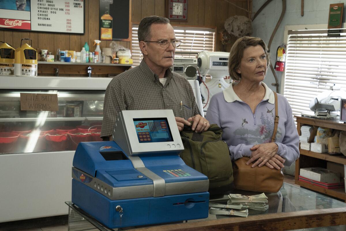 Bryan Cranston and Annette Bening stand at a lottery ticket machine in “Jerry & Marge Go Large.”
