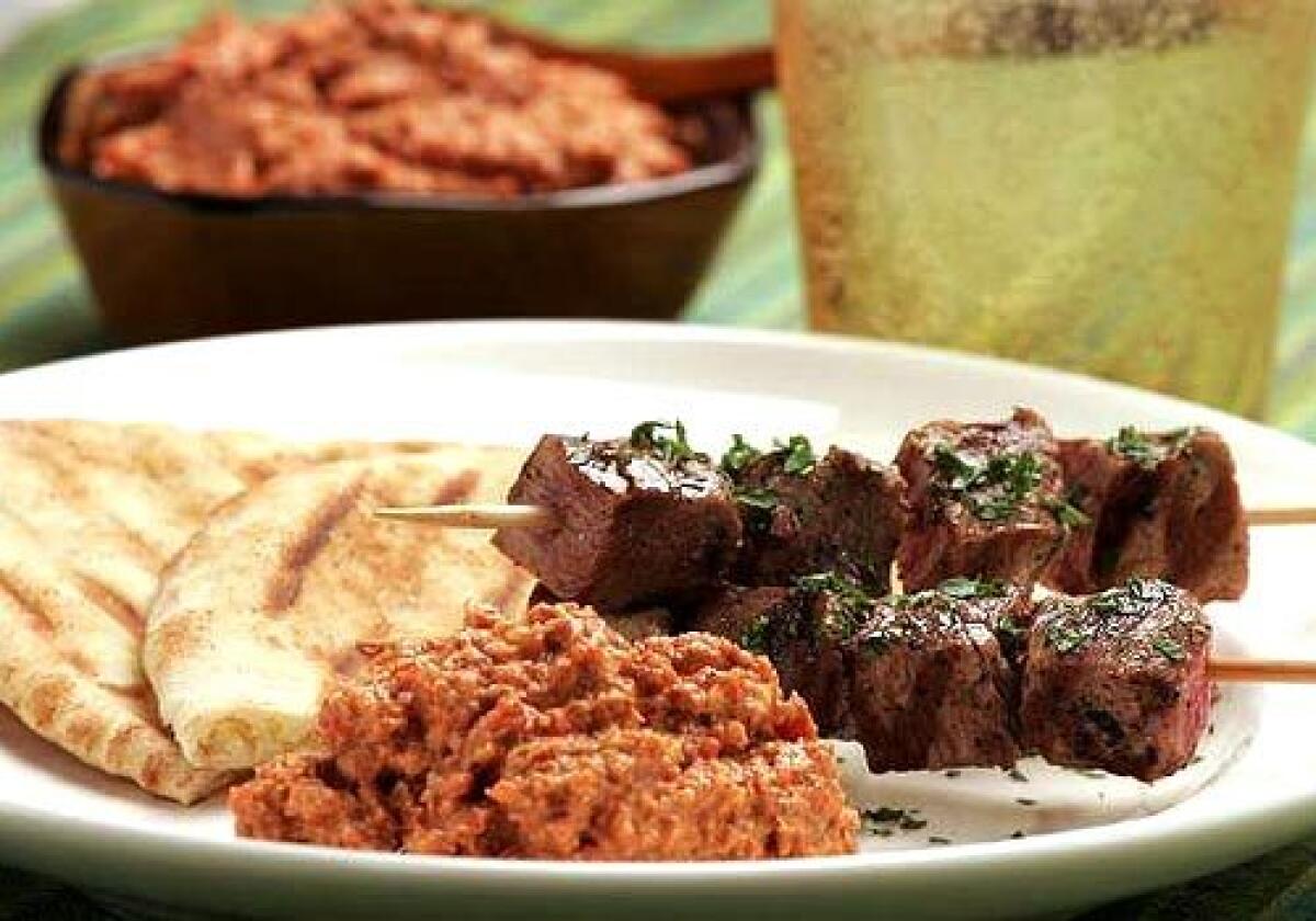 Muhamarra, a condiment made of ground walnuts, roasted red peppers and pomegranate molasses, is perfect with grilled meat such as lamb kebabs.