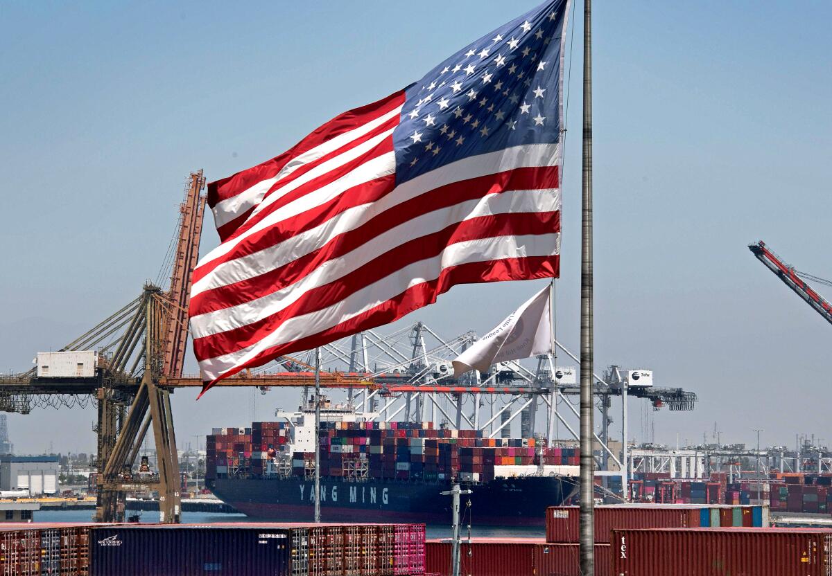 U.S. flag flies over a container ship in the Port of Long Beach