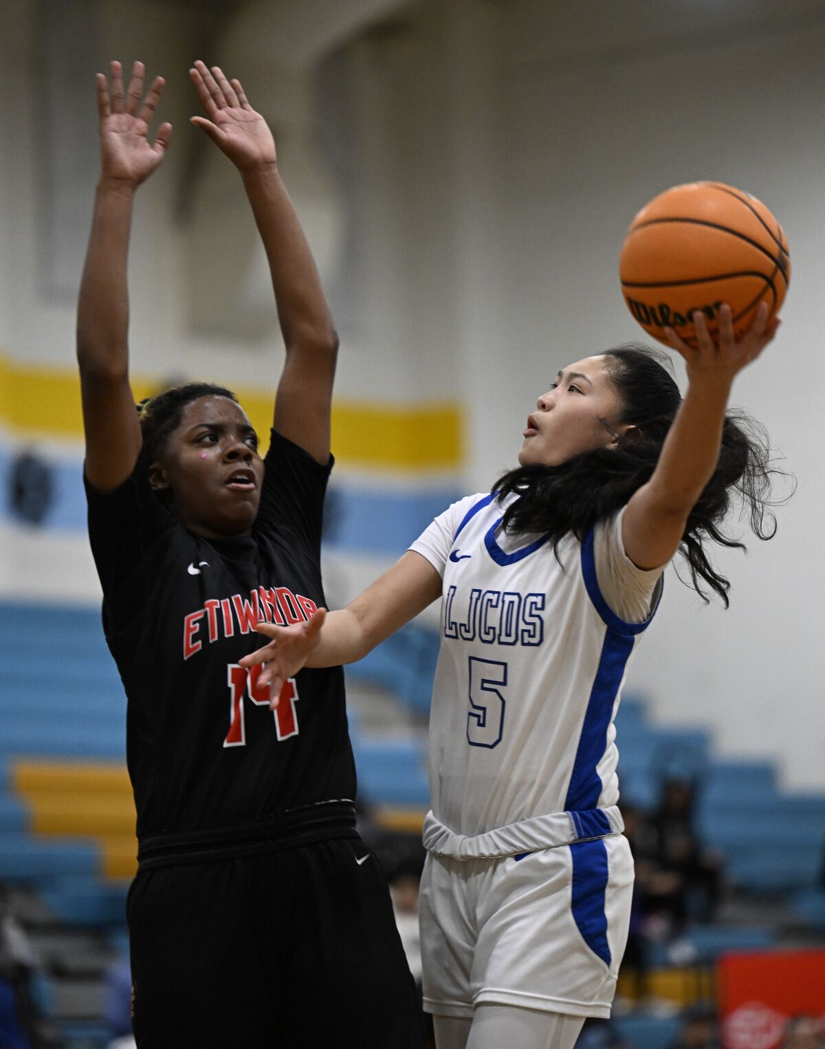 La Jolla Country Day's Sumaya Sugapong shoots over Etiwanda's Majesty Cade on Jan. 28 during the ESPN BorderBoyz Classic.