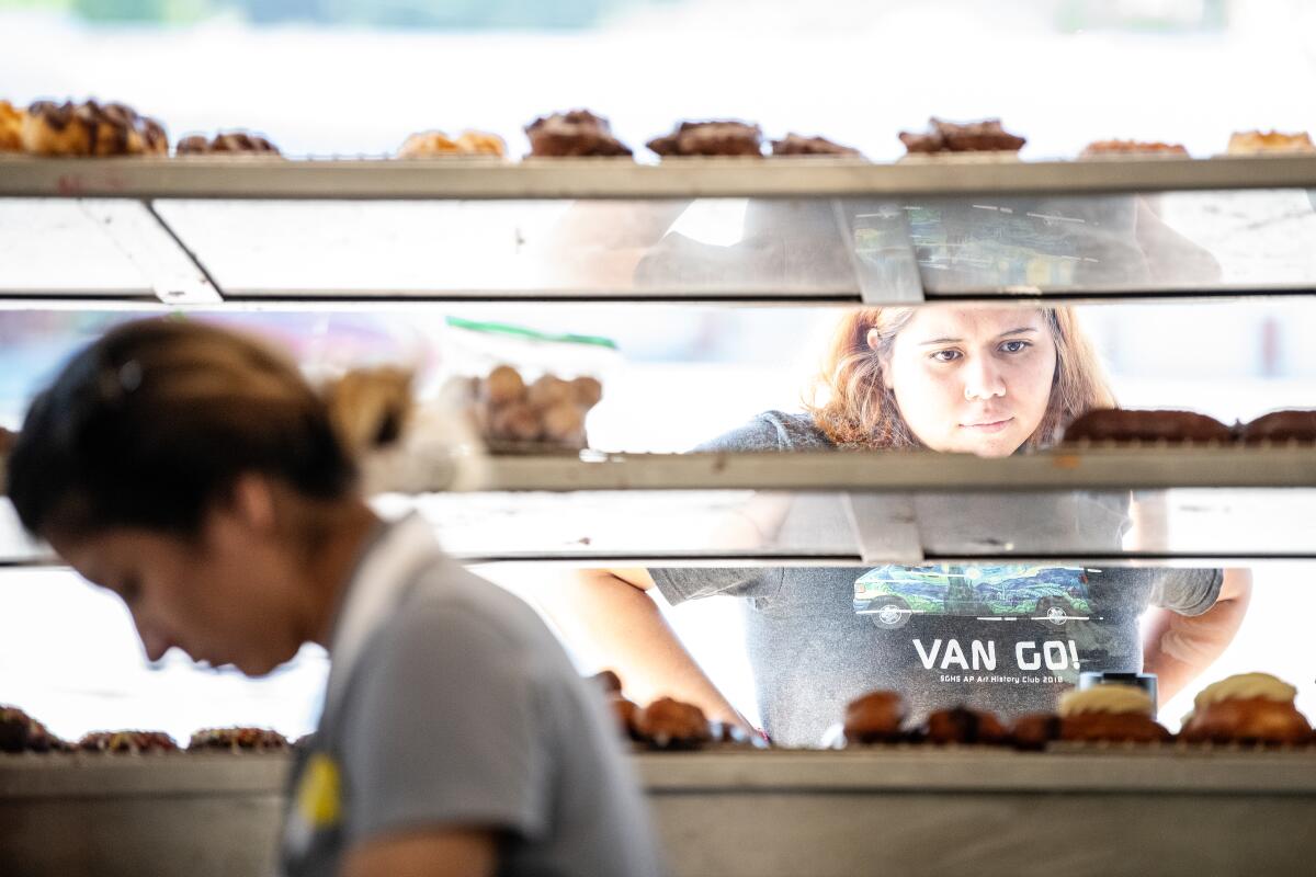 A customer browses the selection of doughnuts at the Donut Man in Glendora.