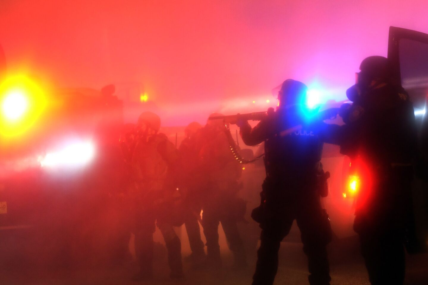 Police are engulfed in tear gas during clashes with protesters after the grand jury decision not to indict the police officer who killed 18-year-old Michael Brown in Ferguson, Mo.