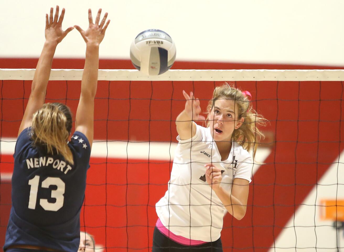 Laguna Beach High's Piper Naess puts the ball away for a kill past Newport Harbor's Jasmine Amirie in Wave League volleyball match on Thursday.