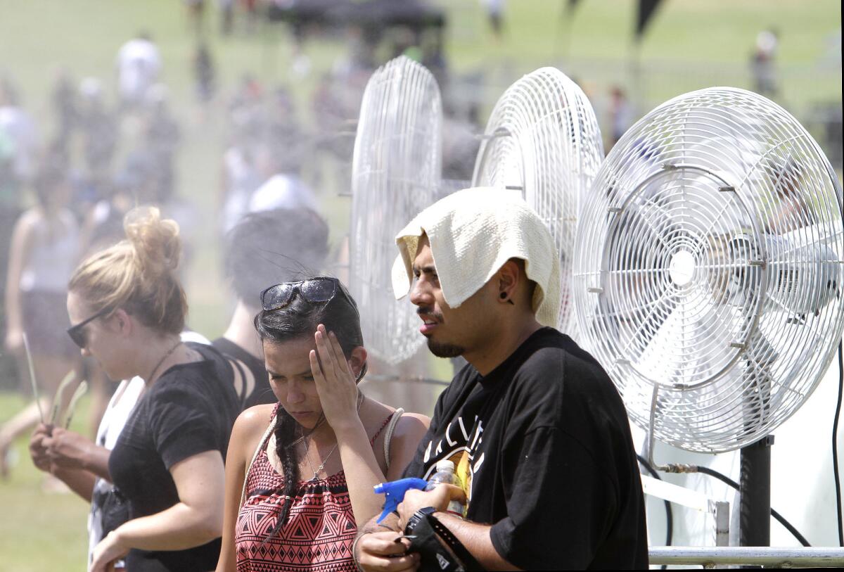 Fans try to cool off amid the brutal heat of Day 1 of 2013's edition of Rock the Bells at San Manuel Amphitheater in San Bernardino.