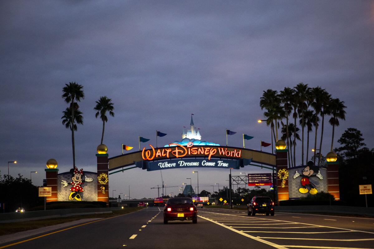 Cars drive toward a sign that says Walt Disney World.