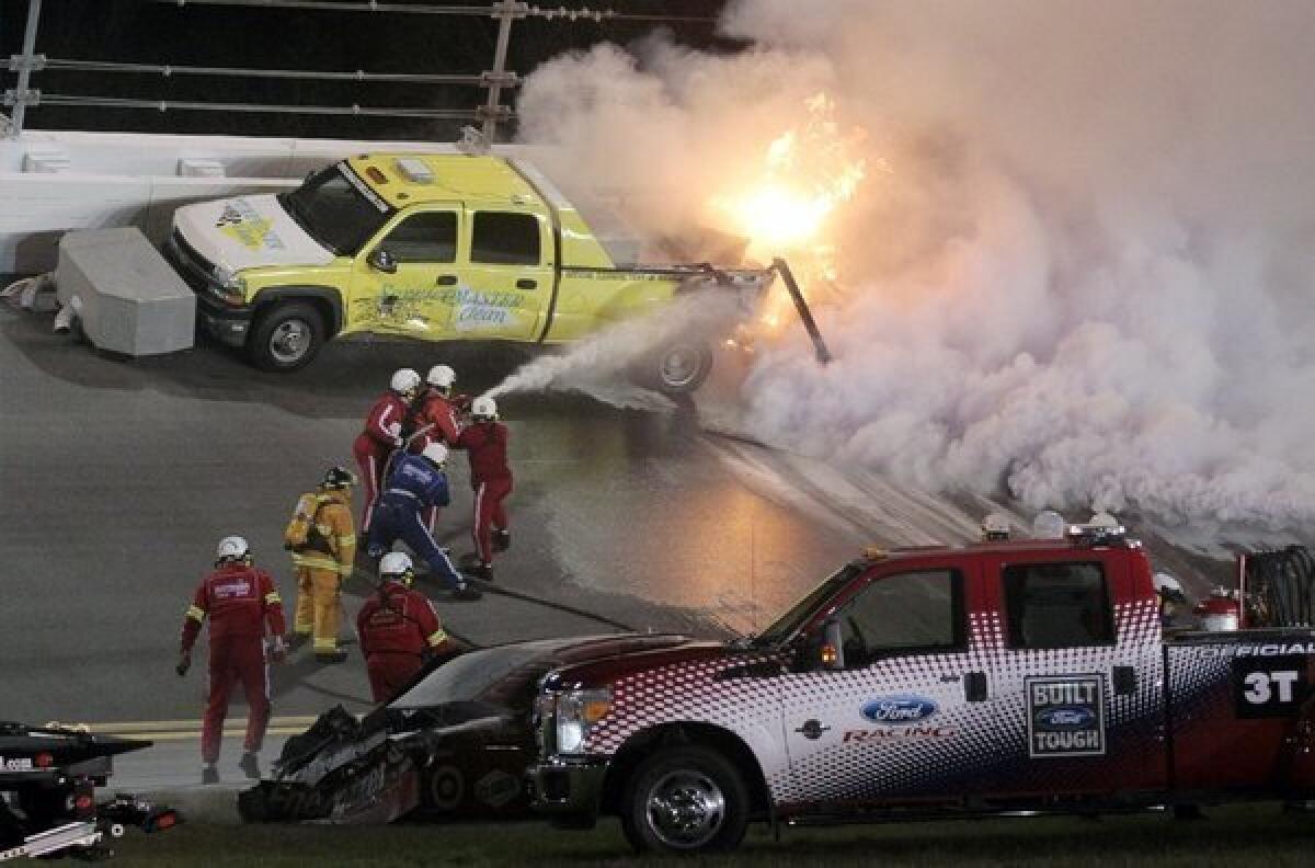 Emergency workers extinguish a fire burning a jet dryer during the NASCAR Daytona 500 on May 27. Juan Pablo Montoya's car struck the dryer during a caution flag, starting the fire, after something on the car broke. Matt Kenseth won the race.