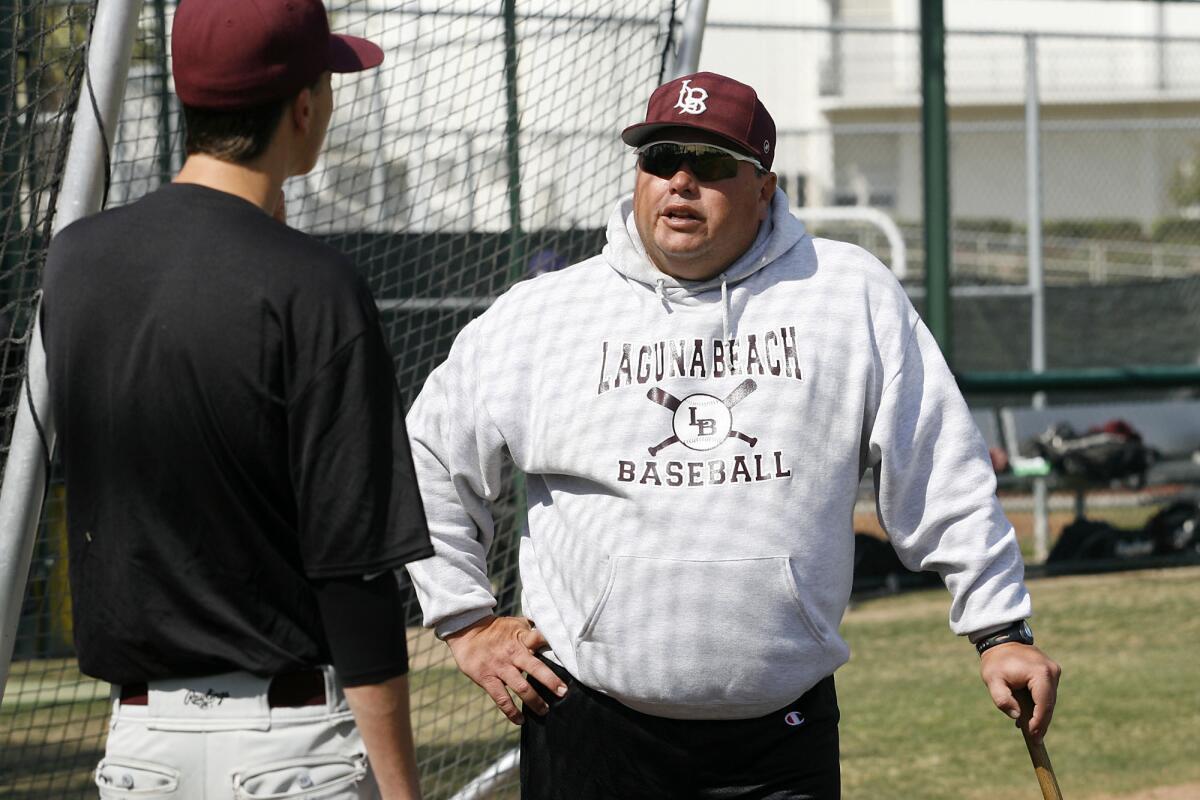 Laguna Beach High School's Varsity baseball Coach Jeff Sears speaks to one of his players at practice at Laguna Beach High