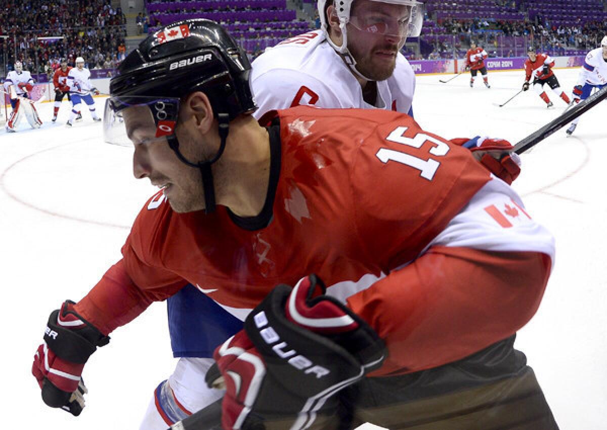 Ducks captain Ryan Getzlaf, battling in the corner with Norway's Jonas Holoes during a gamer earlier in the Olympic hockey tournament, and Canada will play for the gold medal Sunday against Sweden.