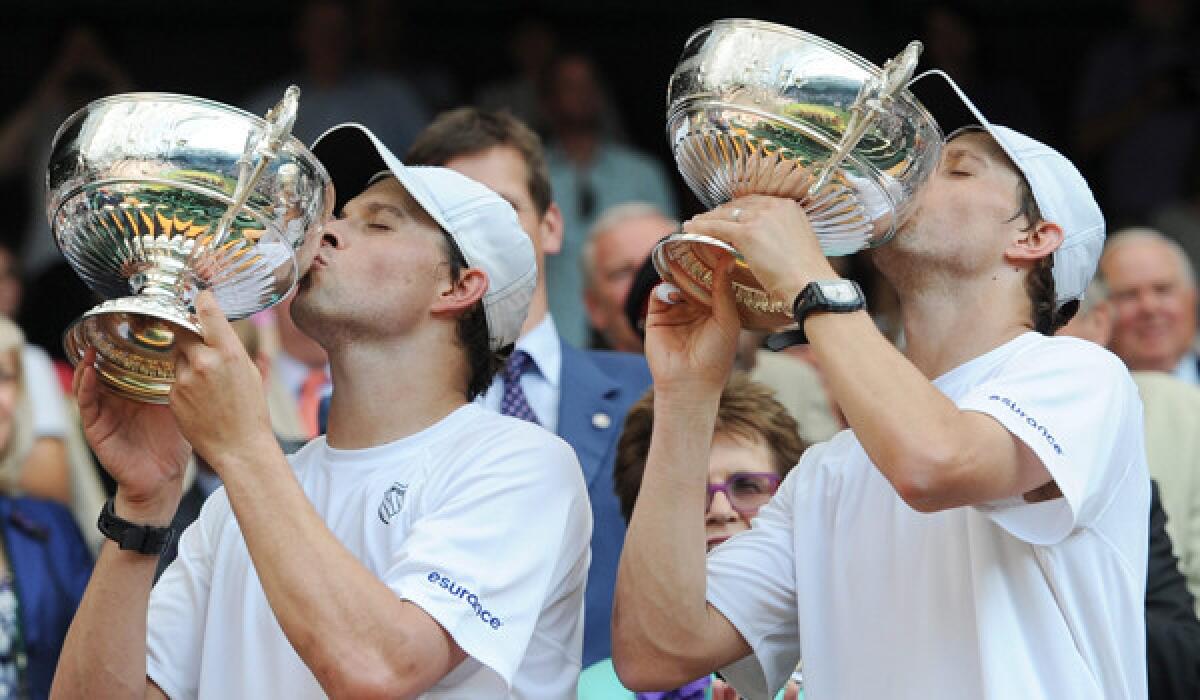 Bob, left, and Mike Bryan celebrate winning the Wimbledon doubles title in 2013.