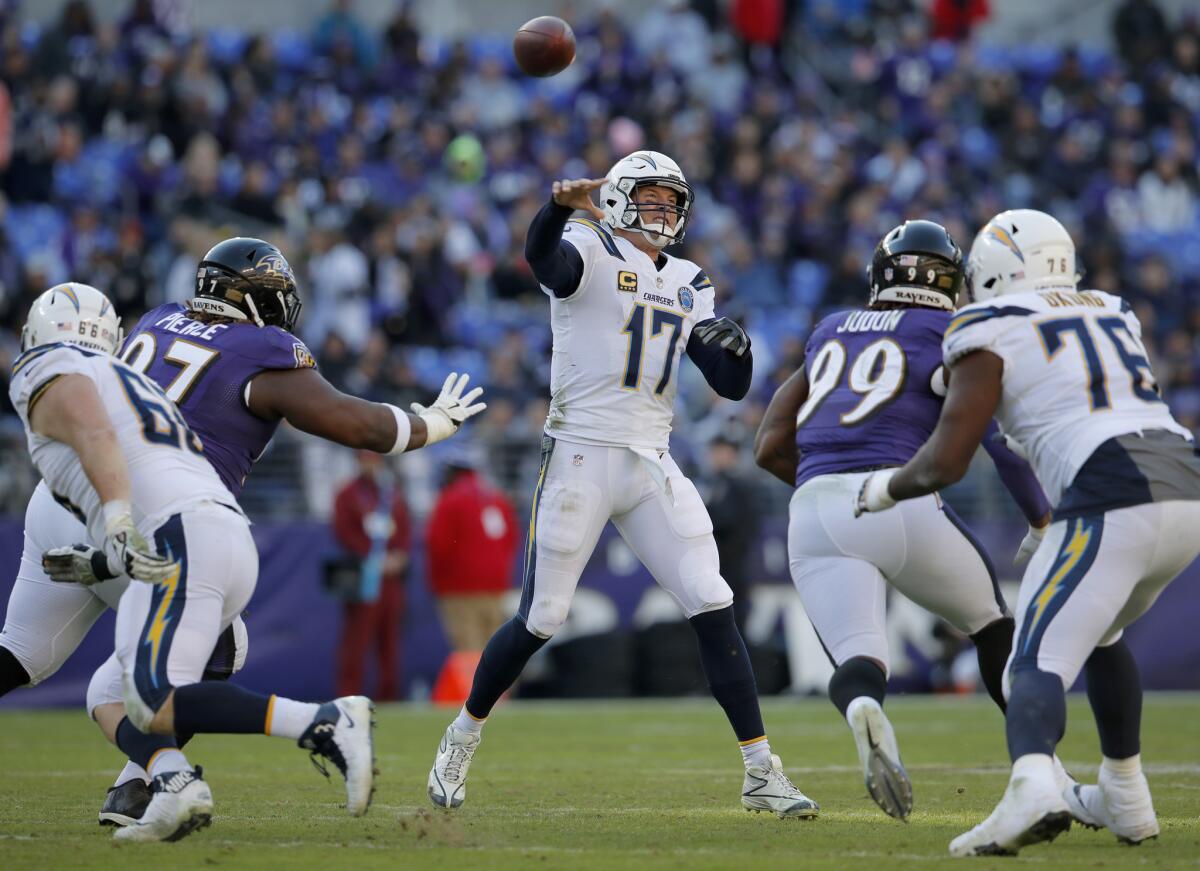 Los Angeles Chargers quarterback Philip Rivers (17) passes the ball in the second half of an NFL wild card playoff football game against the Baltimore Ravens, Sunday, Jan. 6, 2019, in Baltimore. Moving in on the play are Los Angeles Chargers offensive guard Dan Feeney (66), Baltimore Ravens defensive tackle Michael Pierce (97), Baltimore Ravens outside linebacker Matt Judon (99), and Los Angeles Chargers offensive tackle Russell Okung (76).