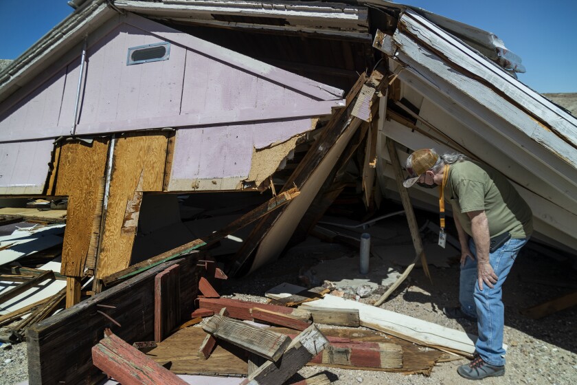 Jim Shearer, the BLM’s archaeologist for the Barstow field office, looks under a collapsed building