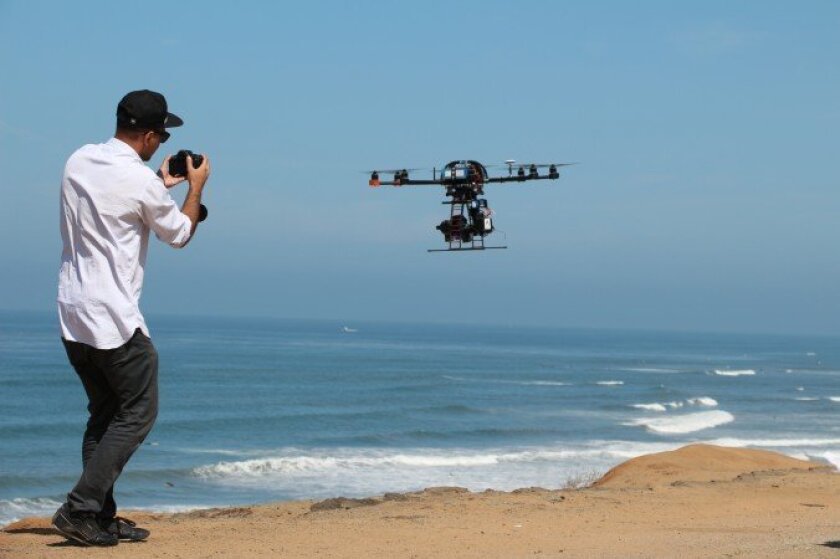 An Aerial Mob employee shows off their unmanned aerial vehicle, commonly known as a drone. Last month, the local company flew a drone on set of a Motion Picture Association of America production for the first time.