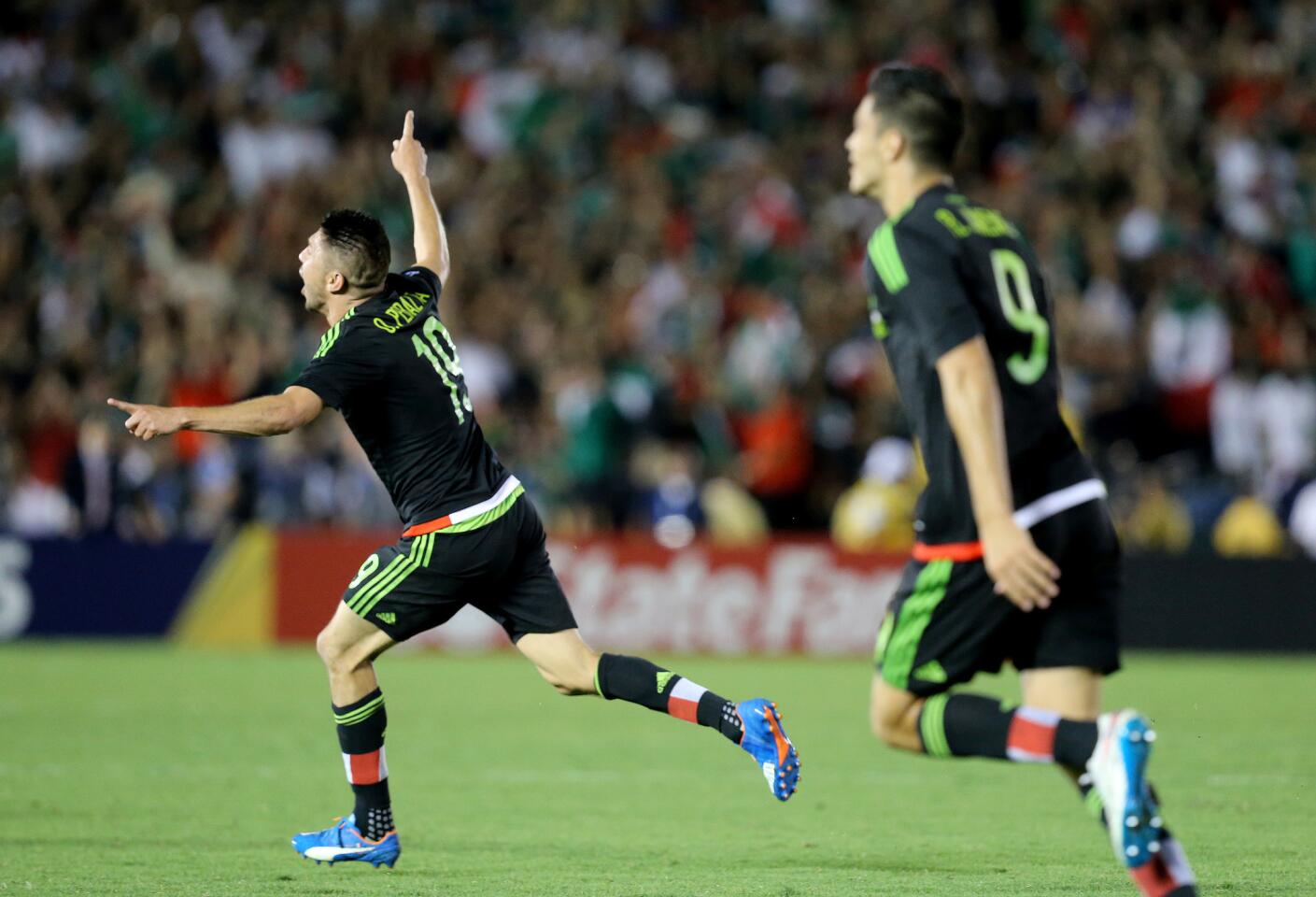 Mexico forward Oribe Peralta celebrates a goal against the U.S. in the first overtime period of a CONCACAF Cup game at the Rose Bowl.