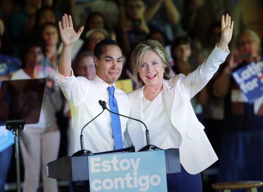 Hillary Clinton, right, stands with Housing and Urban Development Secretary Julian Castro after she was introduced during a campaign event in San Antonio.