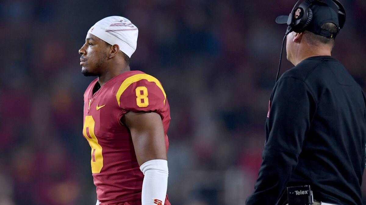 USC's Iman Marshall reacts with head coach Clay Helton after his unsportsmanlike penalty to give California a first down during the fourth quarter against on Saturday at the Coliseum.