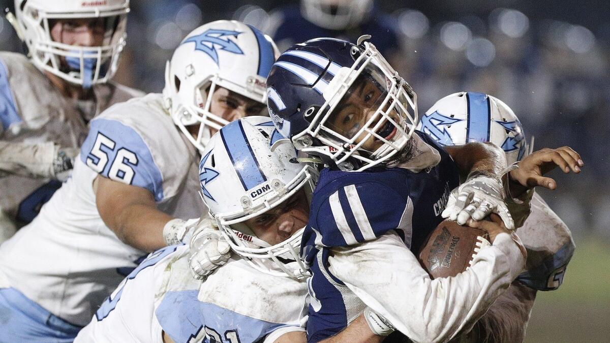 Corona del Mar High's defense collides with Camarillo's Jesse Valenzuela in the semifinals of the CIF Southern Section Division 4 playoffs on the road on Nov. 16.