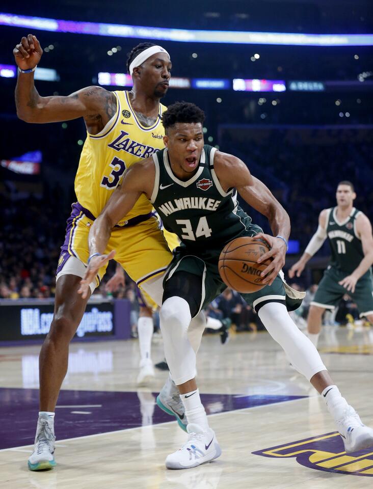 Lakers center Dwight Howard guards Bucks forward Giannis Antetokounmpo during the first half of a game March 6 at the Staples Center.