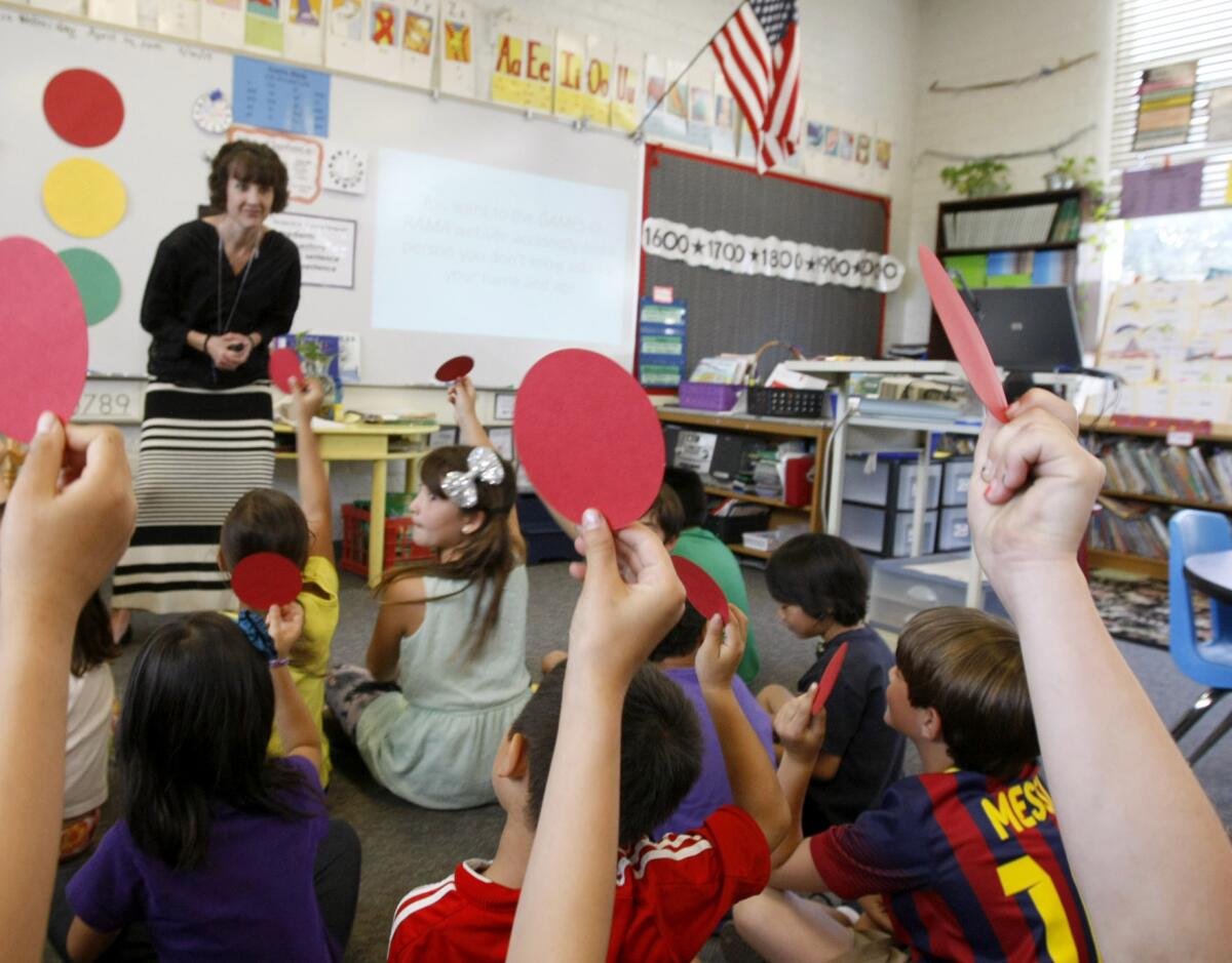Second grade teacher Pam Watts teaches her students about digital citizenship in her Paradise Canyon Elementary School classroom in La Cañada Flintridge on Wednesday, April 16, 2014. Above, students answer a question with a red circle indicating the question was not a safe activity to do while on the internet. Her students are learning how to be safe and cautious while using the internet.