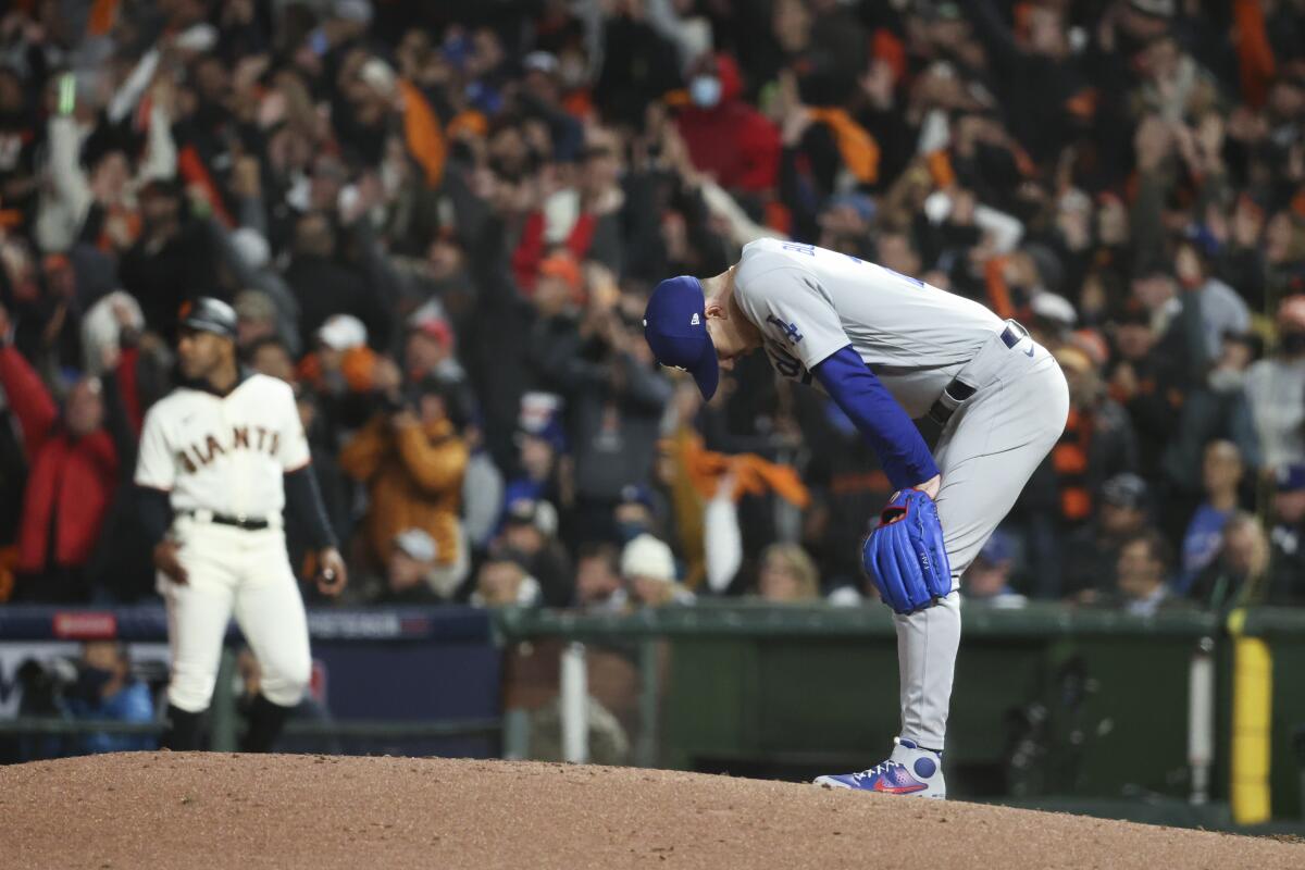 Dodgers starting pitcher Walker Buehler reacts after giving up a solo home run to San Francisco's Kris Bryant.