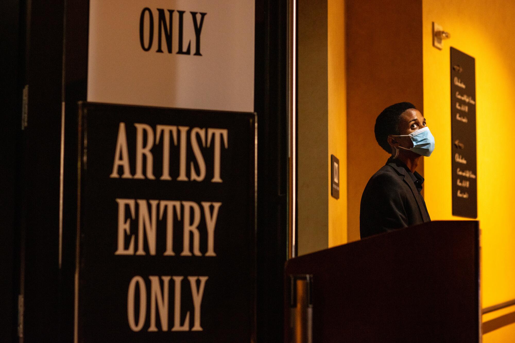 A security guard clad in a mask near the artist's entrance at Dolby Theatre the day before the 2020 Billboard Music Awards.