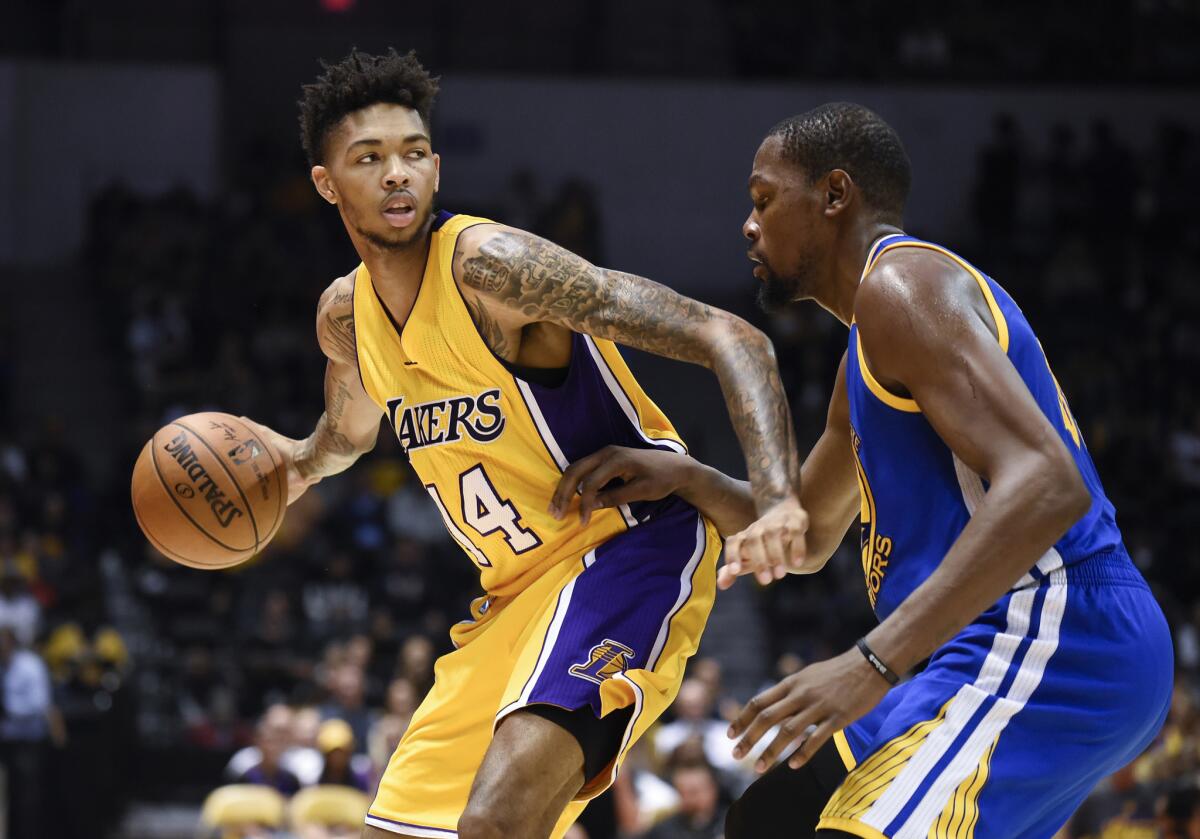 Lakers forward Brandon Ingram (14) tries to drive past the defense of Golden State Warriors forward Kevin Durant during the second half.