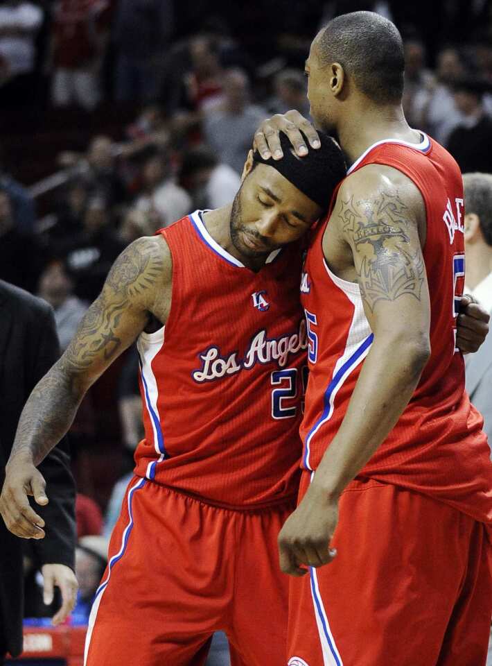 Clippers guard Mo Williams and forward Caron Butler embrace after defeating the Rockets, 105-103 in overtime, on Sunday evening in Houston.