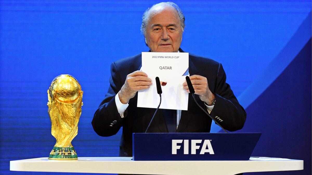 FIFA President Sepp Blatter holds a card announcing Qatar as the host of the 2022 World Cup during a ceremony in December 2010. A FIFA task force has recommended moving the start of the 2022 World Cup to November.