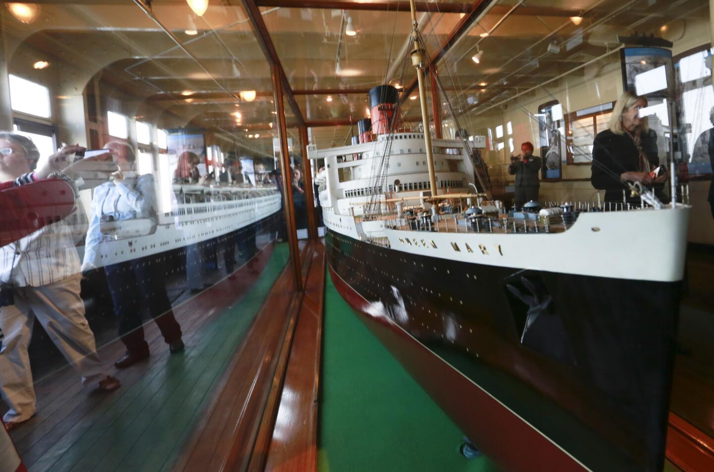 The Queen Mary offered free admission and a day of events, including the dedication of a ship model exhibit, to celebrate the first time her much younger sister ship, the Queen Elizabeth has made a port stop in Long Beach.