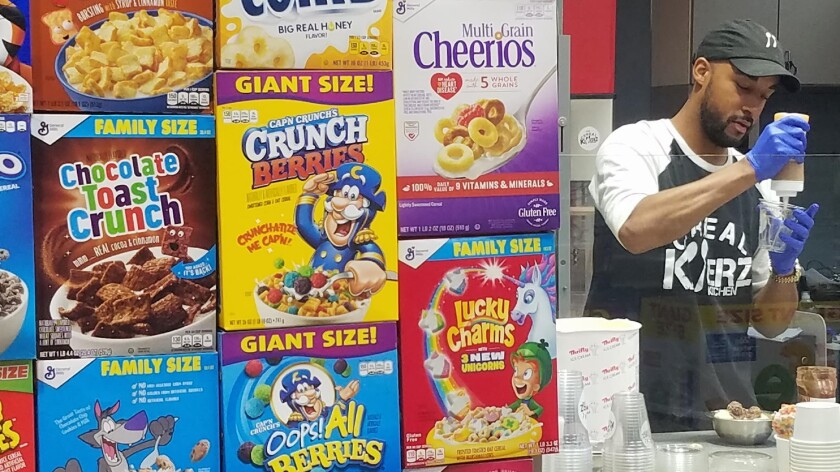 Chris Burns creates a cereal-based ice cream concoction at the Cereal Killerz Kitchen, his new restaurant in the food court of a mall in the Las Vegas suburb of Henderson, Nev.