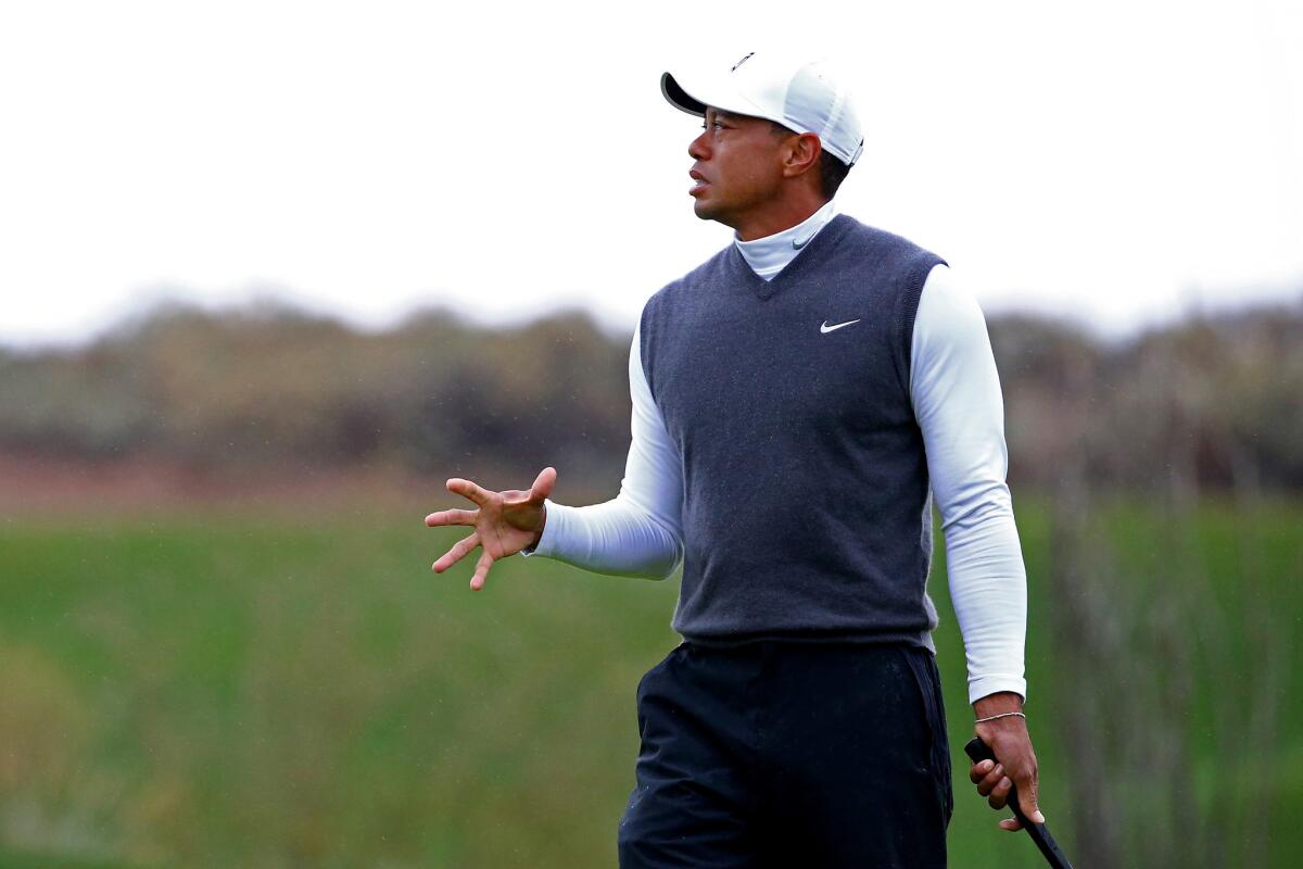 Tiger Woods reacts after missing a putt on the 12th green Friday during his miserable second round of the Phoenix Open.