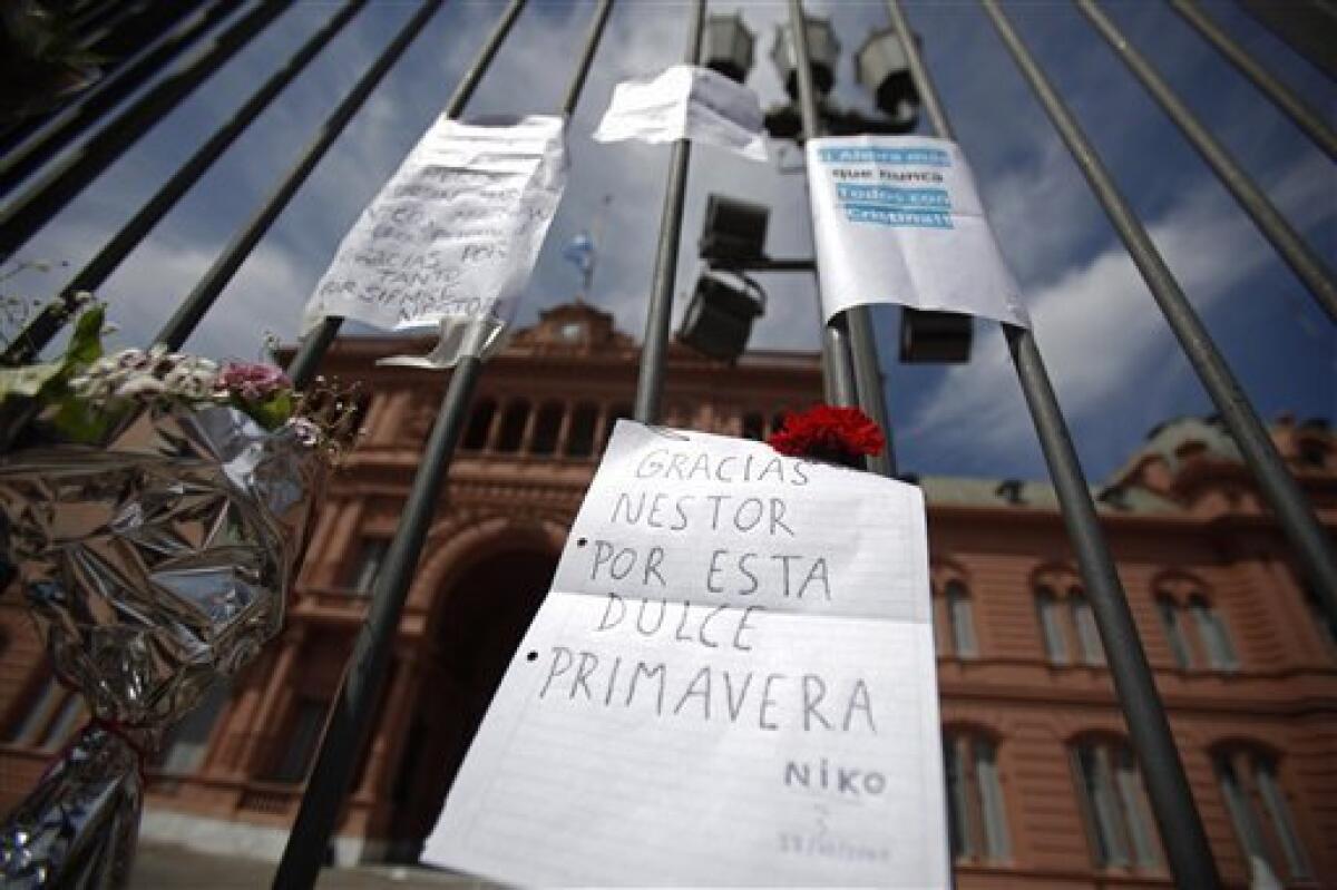 Flowers and letters in honor of former President Nestor Kirchner hang outside the government palace in Buenos Aires, Argentina, Wednesday Oct. 27, 2010. Argentina's former President Nestor Kirchner, who served as president from 2003-2007, died Wednesday after suffering heart attacks at age 60. The letter at center reads in Spanish "Thank you Nestor for this sweet spring. Niko." (AP Photo/Natacha Pisarenko)