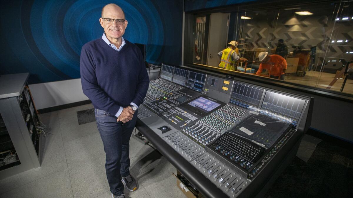 SiriusXM president and chief content officer Scott Greenstein stands before the mixing board for new performance and recording space at the satellite radio service's new facility in Los Angeles.